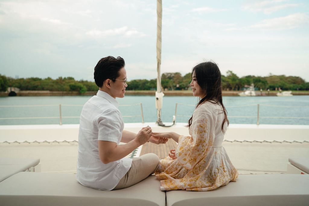 Candlelit golden hour proposal moment on a Yacht Maison yacht in Singapore