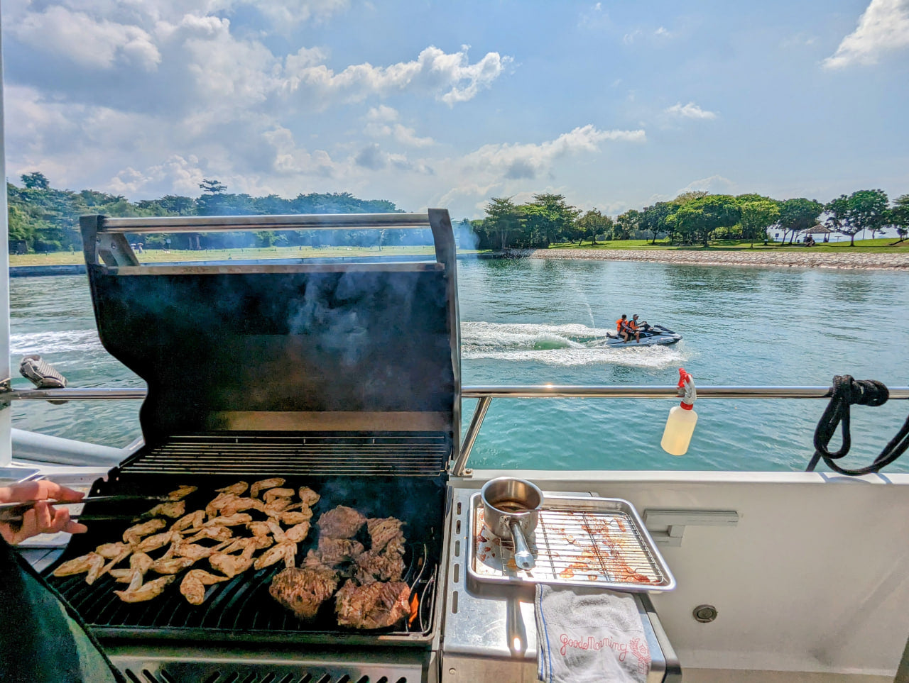 Onboard BBQ catering spread grilling on the deck of a Yacht Maison charter in Singapore
