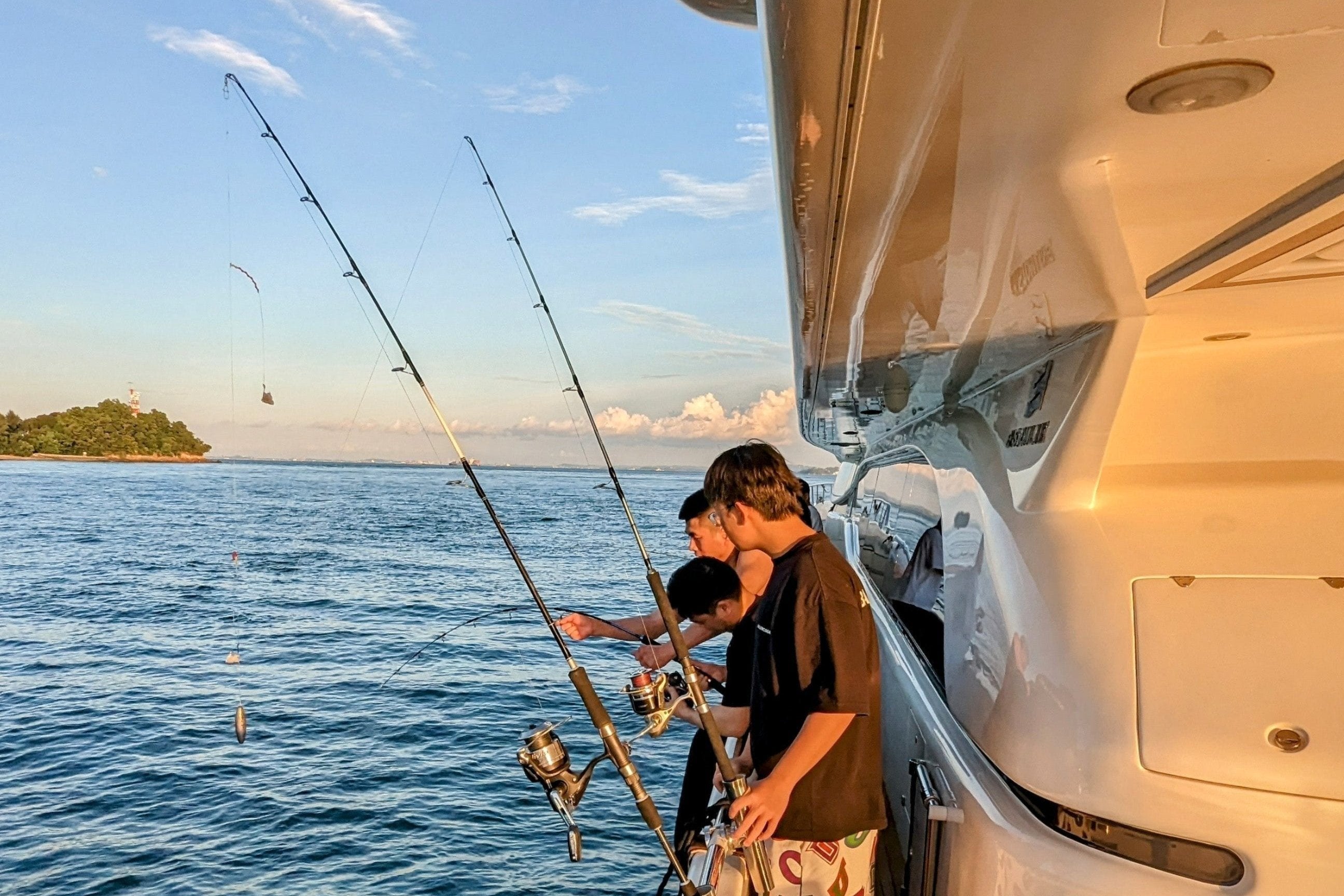Curated fishing charter setup with rods and gear on a Yacht Maison yacht in Singapore