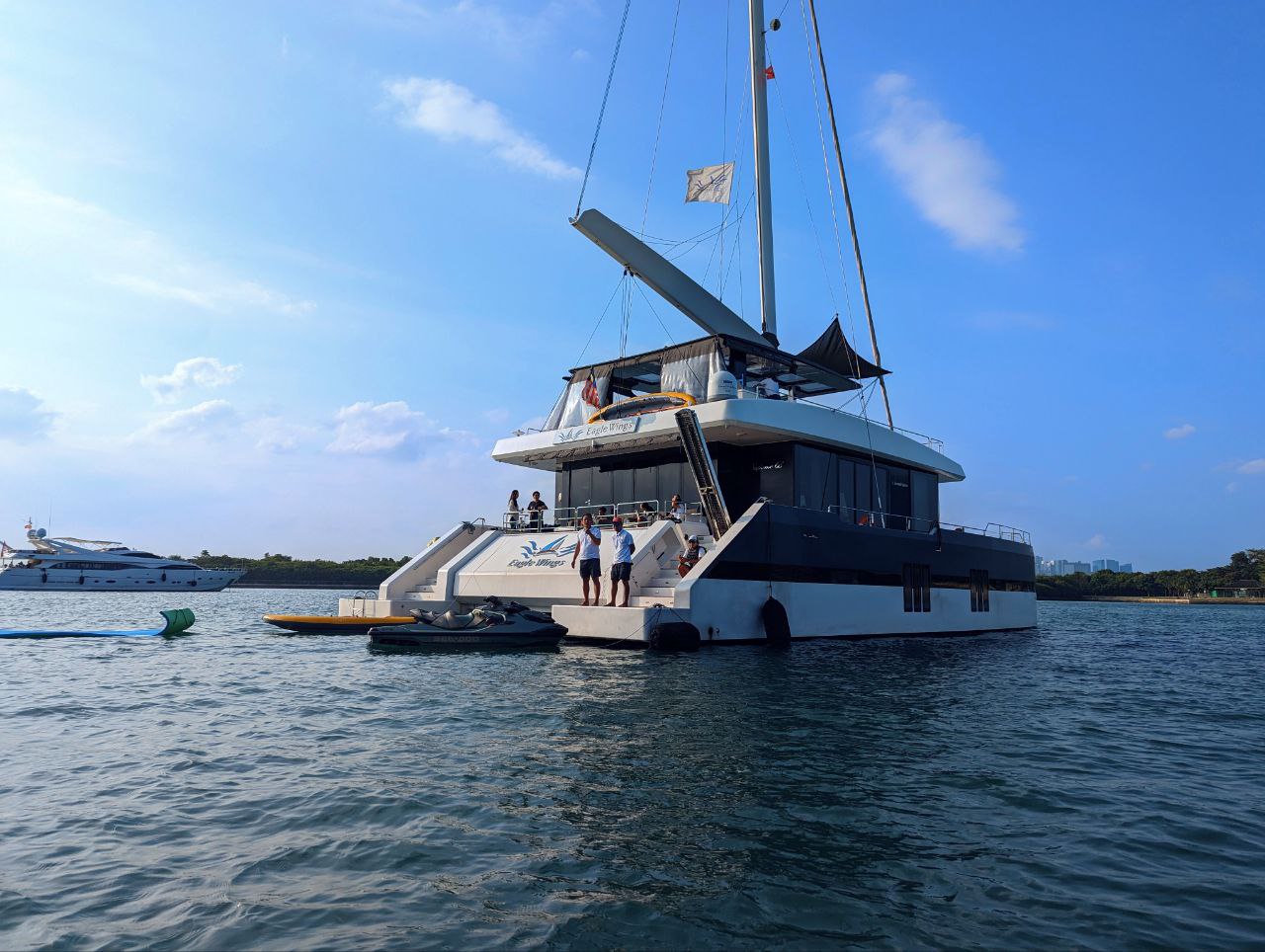 Guests aboard a Yacht Maison luxury yacht charter in Singapore waters